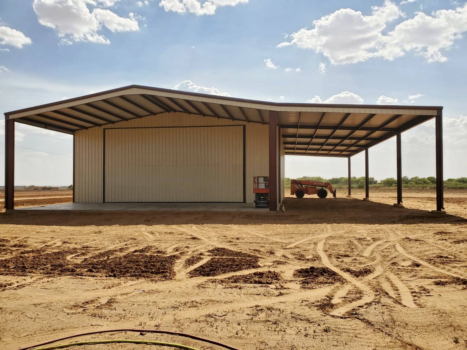 Cream and bronze metal ag shop built by Best In The West Construction in Seminole, Texas